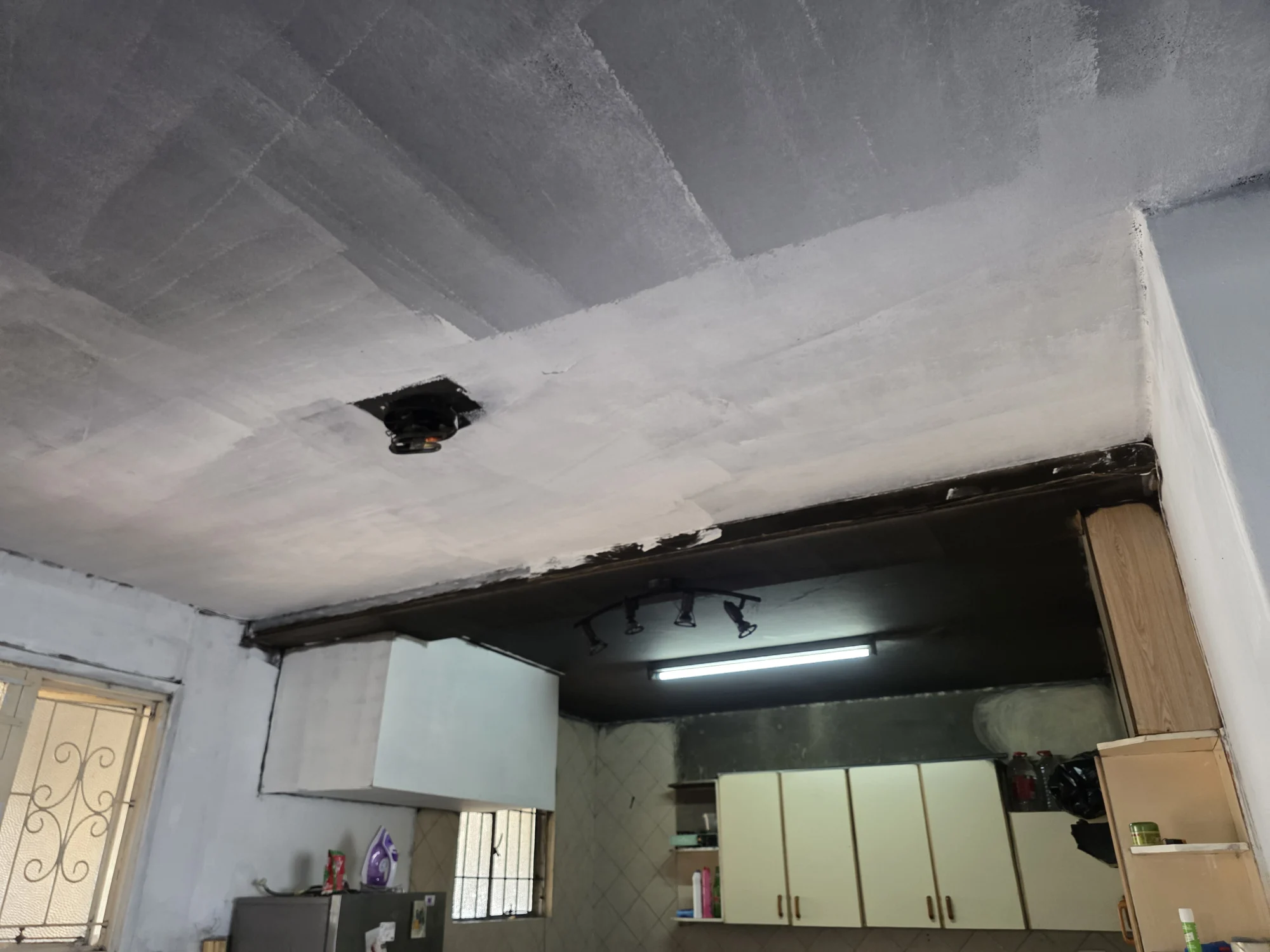 Interior showing damaged ceiling finishes above a kitchen area
