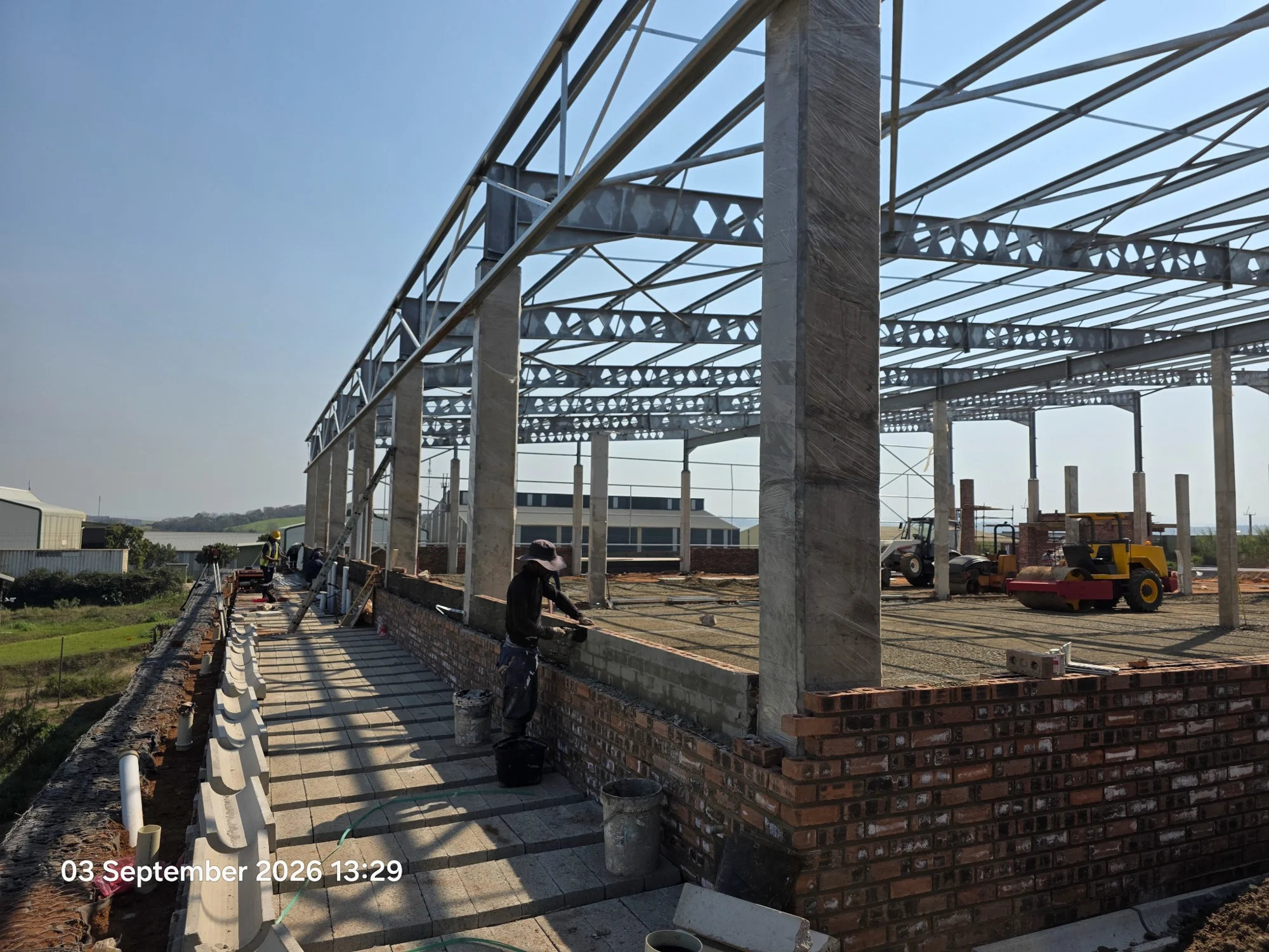 Steel columns and roof trusses forming a large building frame